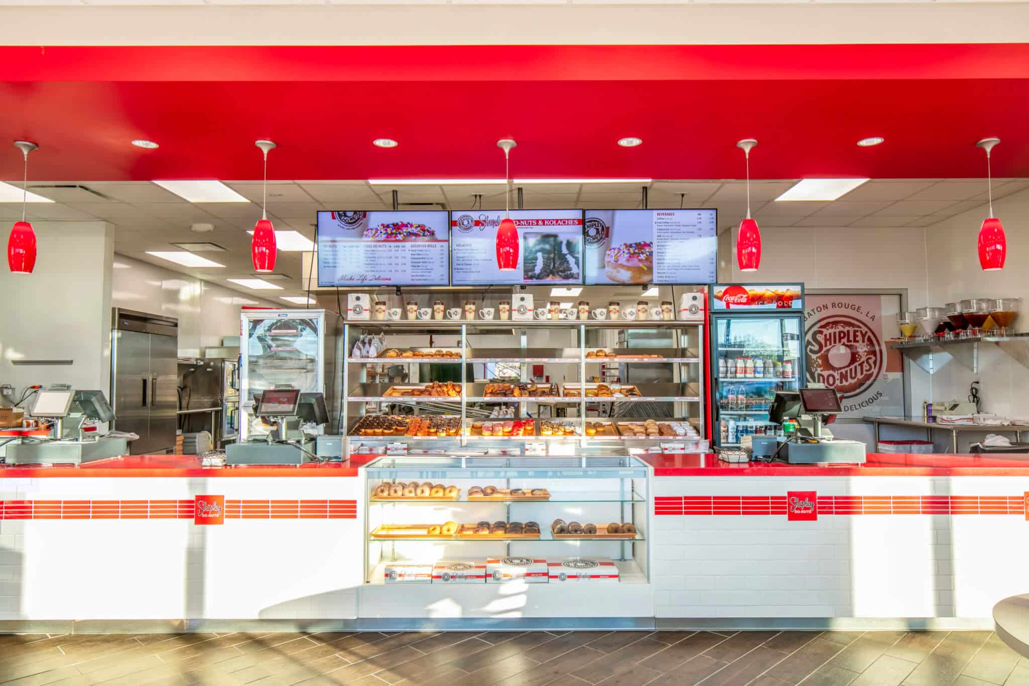The interior of a Shipley donut shop franchise with red walls.